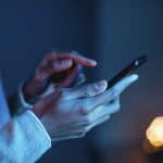 side view man using smartphone