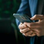 man in suit using smartphone in office 2026 01 06 09 05 02 utc copiar